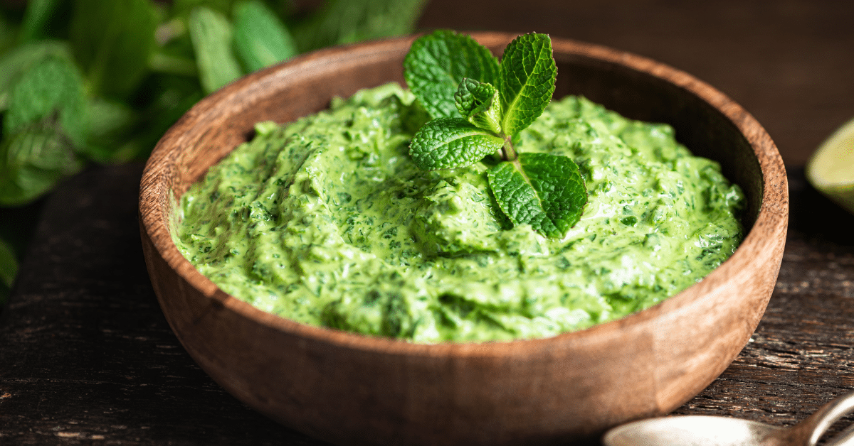 This is a picture of a bowl of green chutney. It links to a Ayurvedic Mint, Pistachio and Cilantro Chutney recipe blog post.